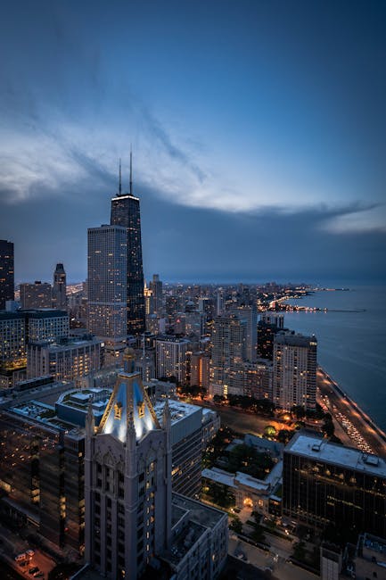 A breathtaking aerial view of Chicago's skyline featuring the iconic John Hancock Center at twilight.